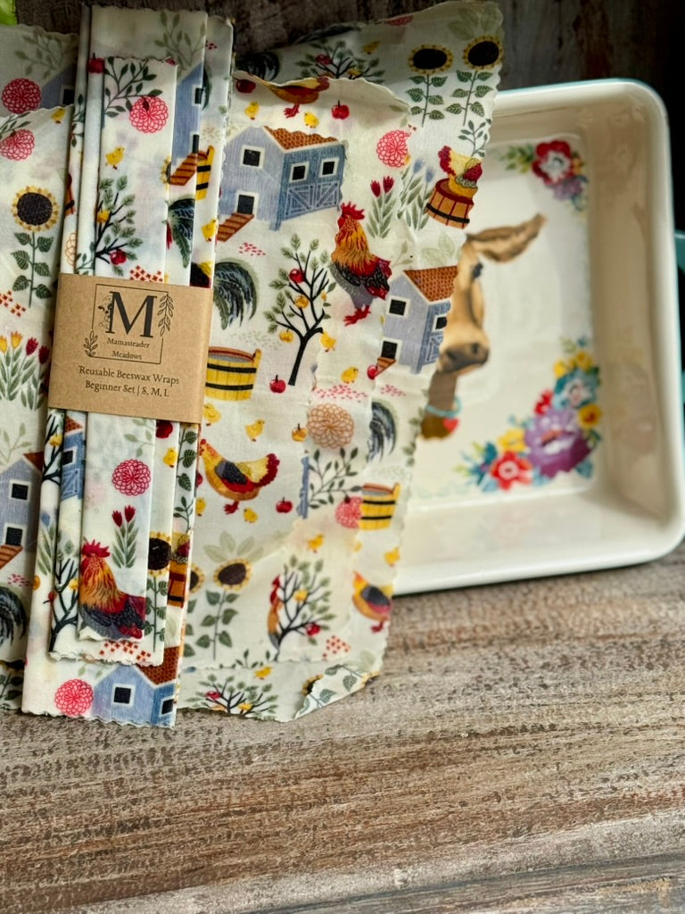 Set of patterned beeswax wraps, beginner set with farm animals and nature designs on a wooden surface.