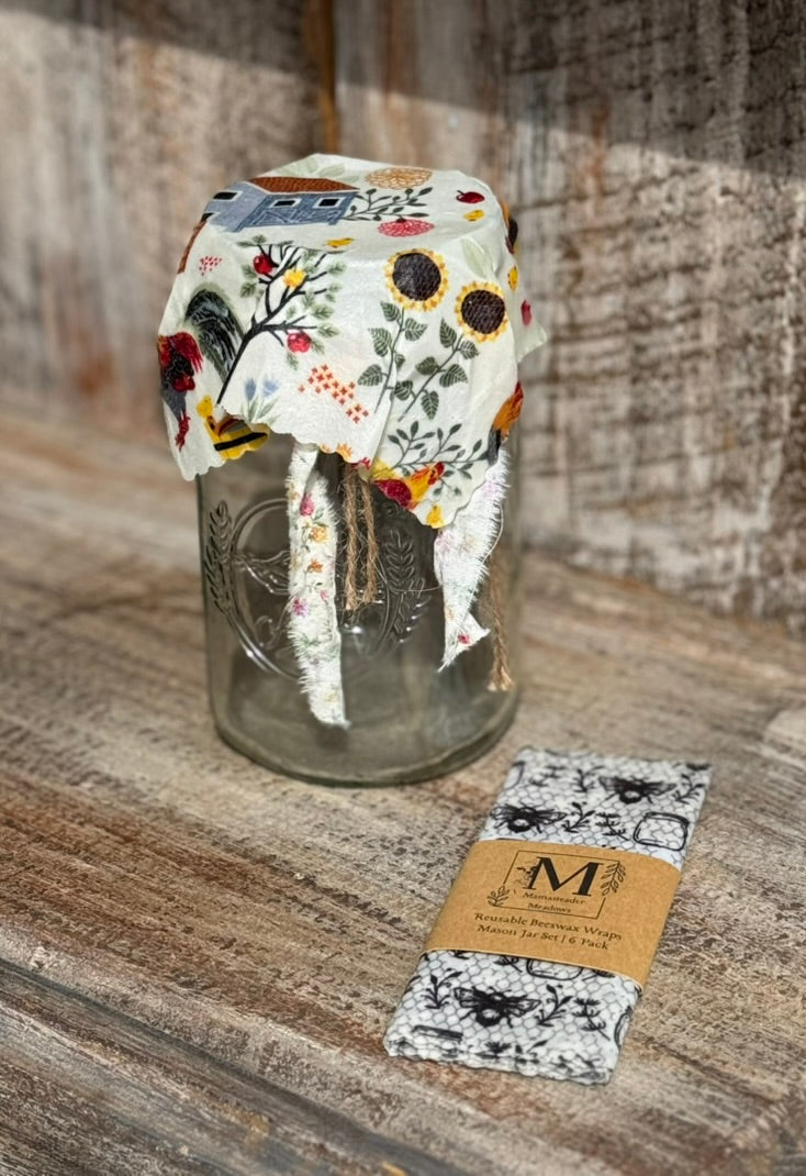 reusable beeswax wrap - jar size with floral design in a glass jar on a wooden surface.